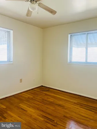 a view of a room with wooden floor and a window