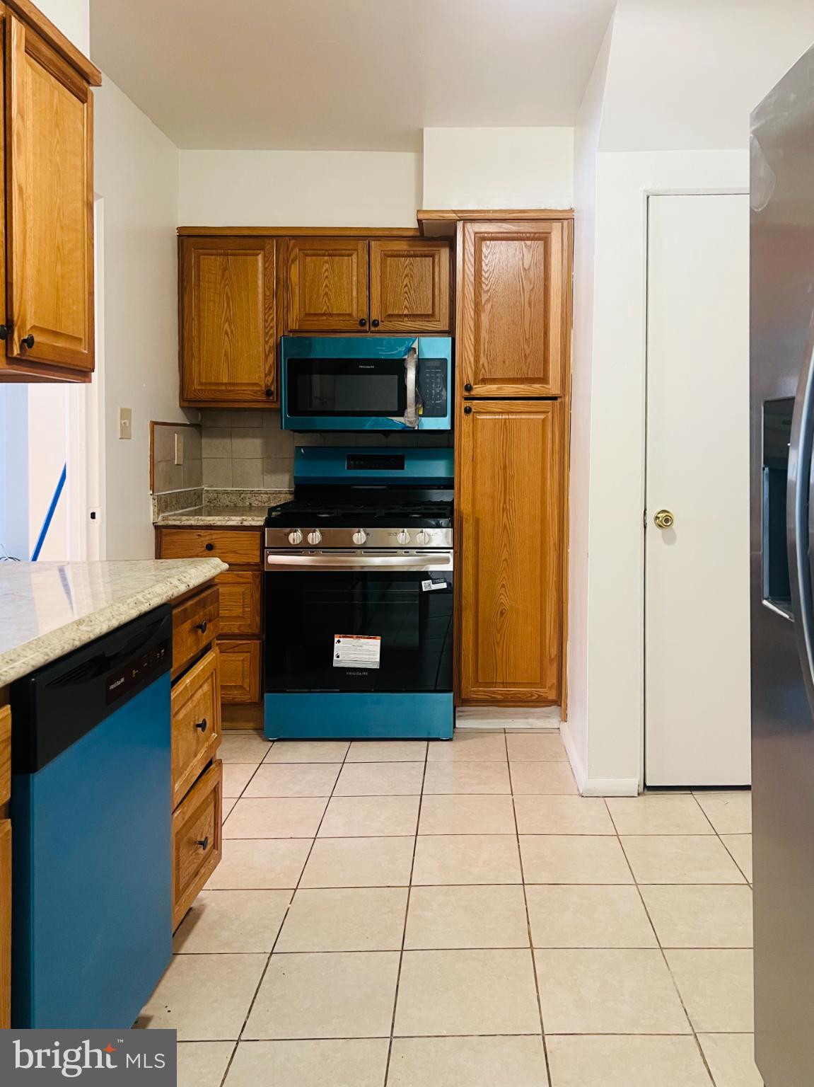 4901 Fitch Place Northeast Washington, DC 20019 - Photo 4 of 45 Charming kitchen with vibrant blue accents.