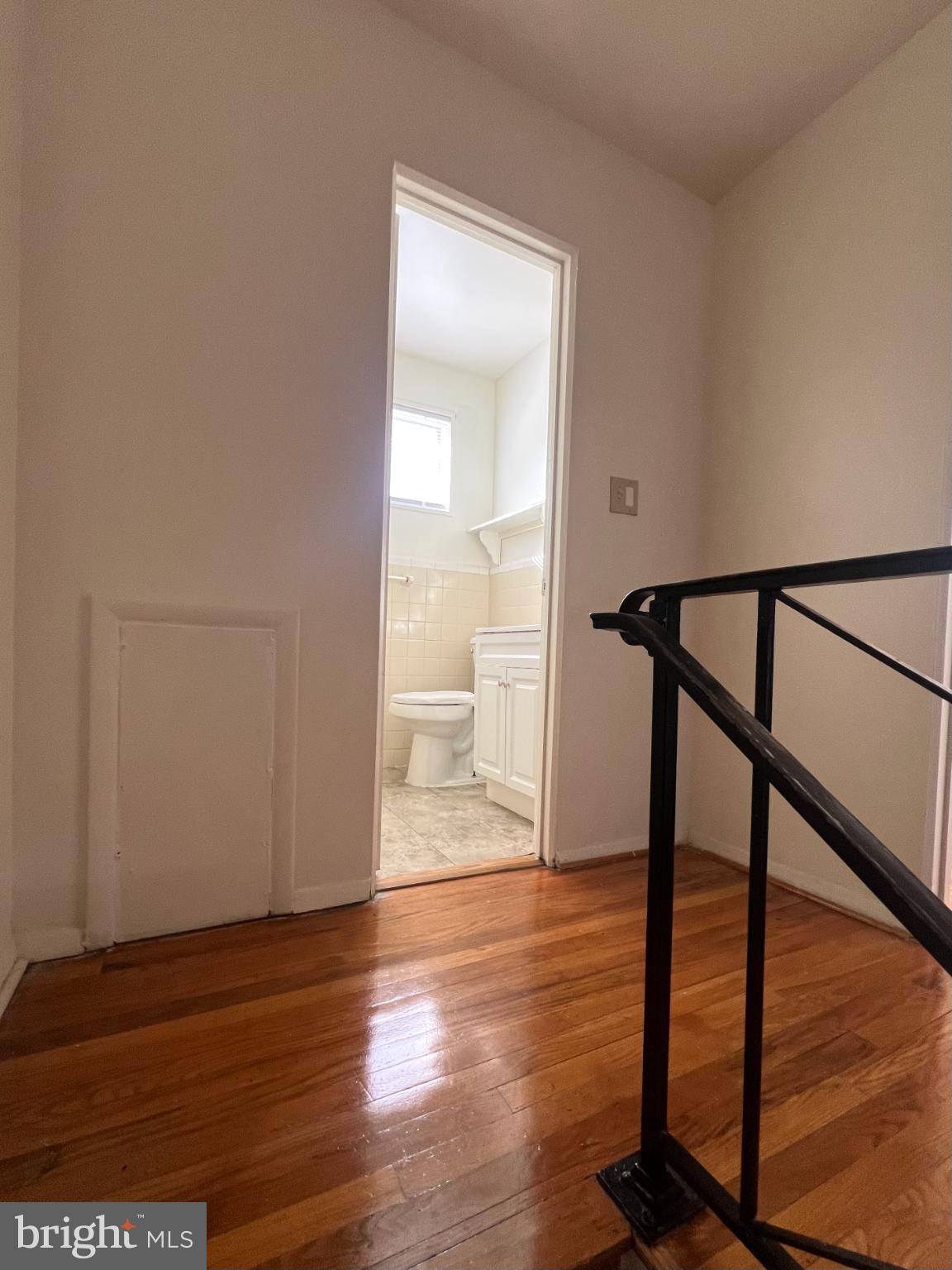 4901 Fitch Place Northeast Washington, DC 20019 - Photo 9 of 45 Bright hallway leading to a serene bathroom.