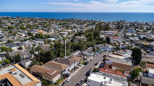 an aerial view of a city with lots of residential buildings and parking space