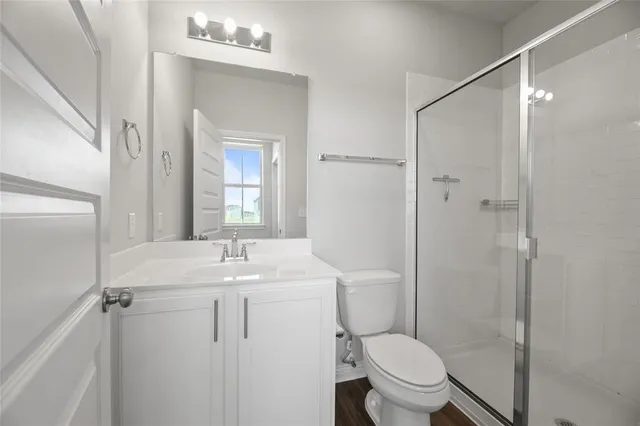 a bathroom with a sink toilet and shower