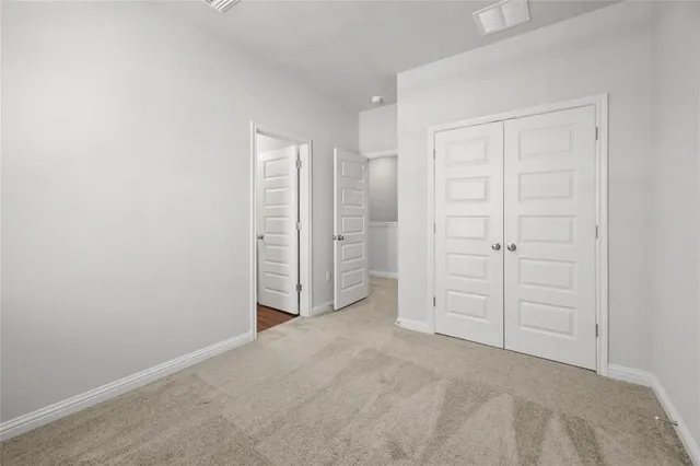 an empty room with closet area