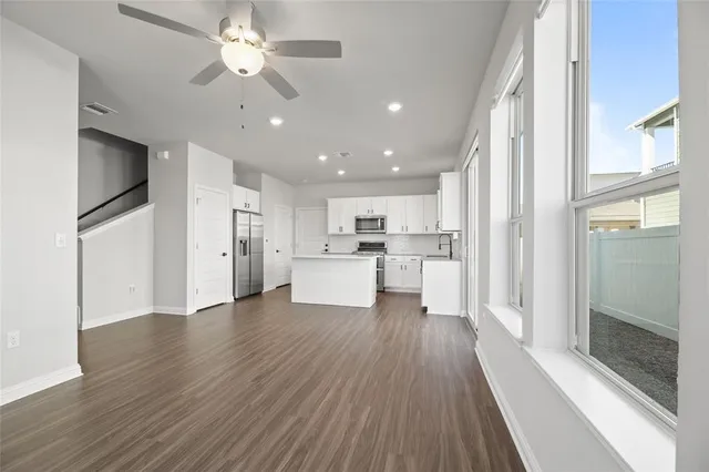a view of kitchen with wooden floor electronic appliances and window