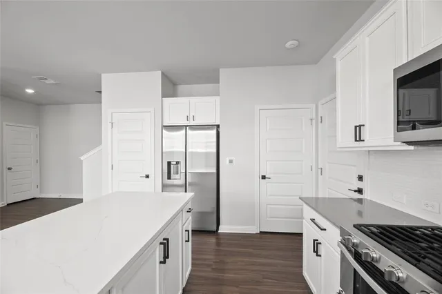 a kitchen with a sink stove and refrigerator