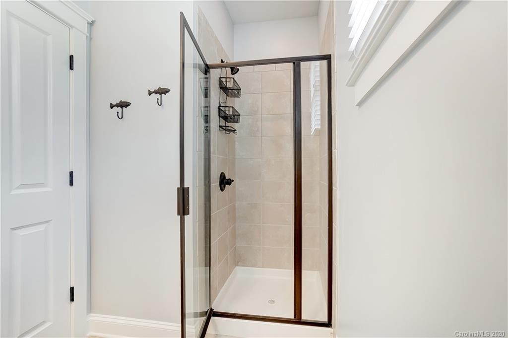 817 Elswick Court Fort Mill, SC 29708 - Photo 22 of 48 a bathroom with a glass shower door