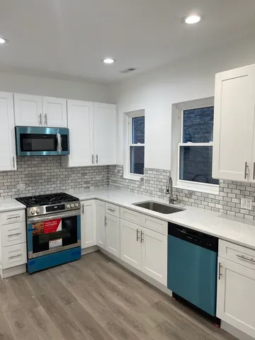 a kitchen with a sink stove and cabinets