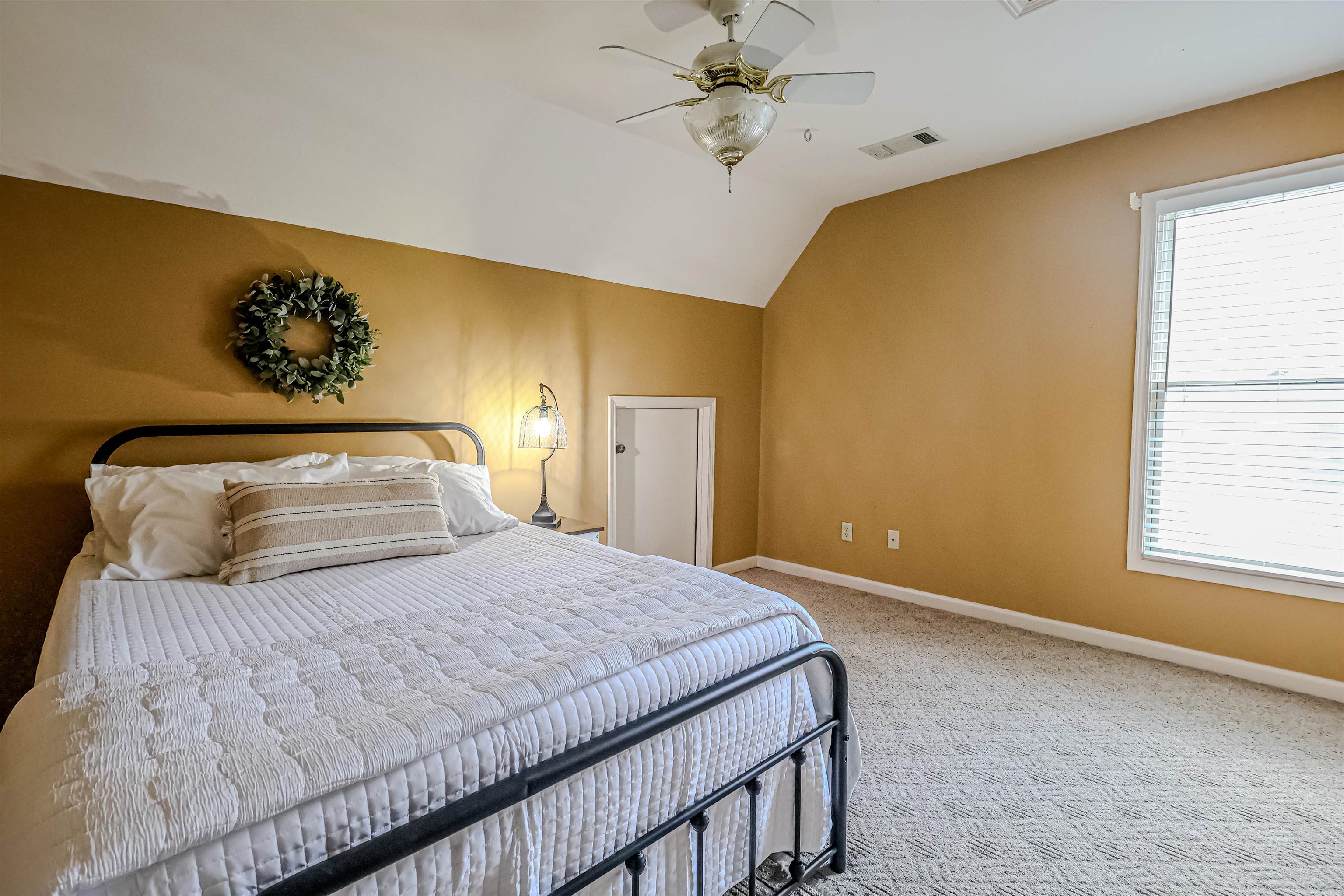 121 Reed Circle Drummonds, TN 38023 - Photo 25 of 38 Carpeted bedroom featuring baseboards, visible vents, vaulted ceiling, and a ceiling fan