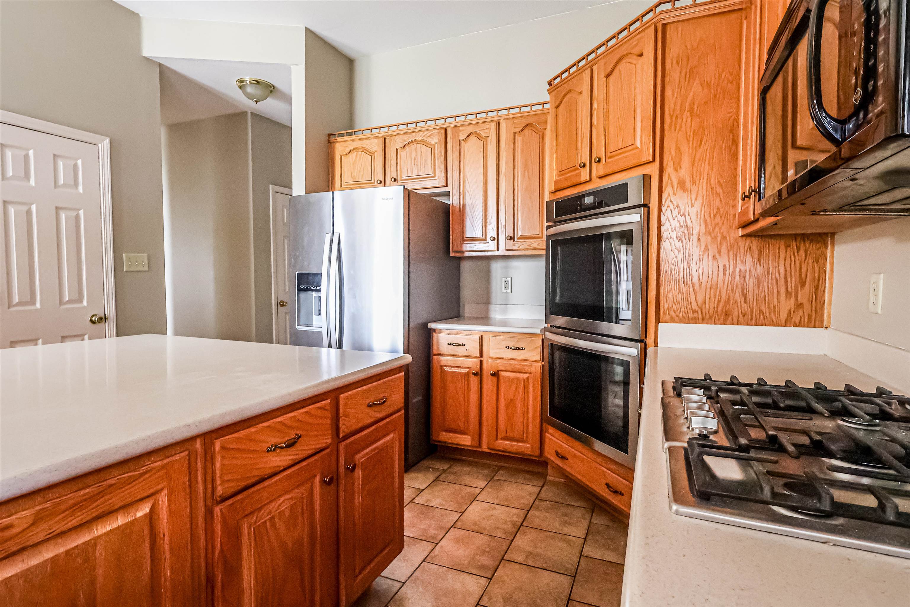 121 Reed Circle Drummonds, TN 38023 - Photo 5 of 38 Kitchen with light countertops, light tile patterned floors, and stainless steel appliances