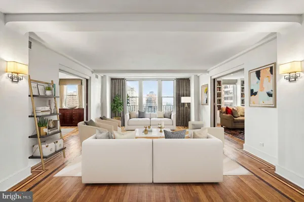 a living room with furniture and large windows