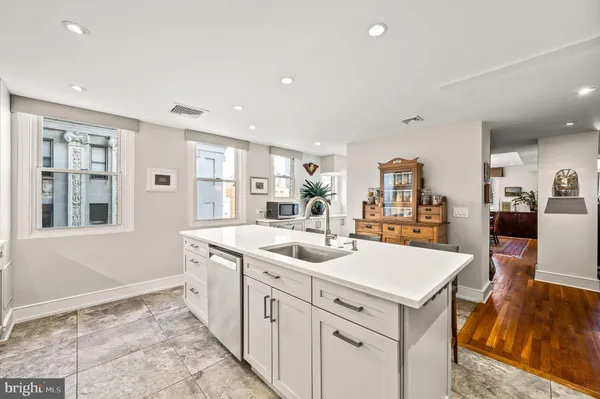a kitchen with sink and refrigerator