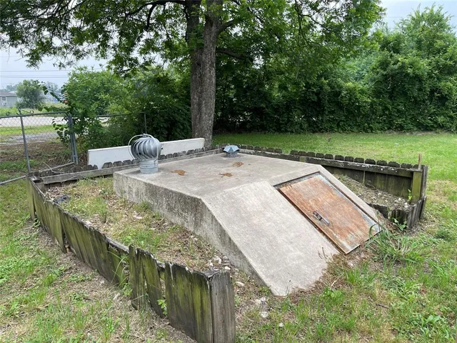 a view of a swimming pool with a patio and a yard