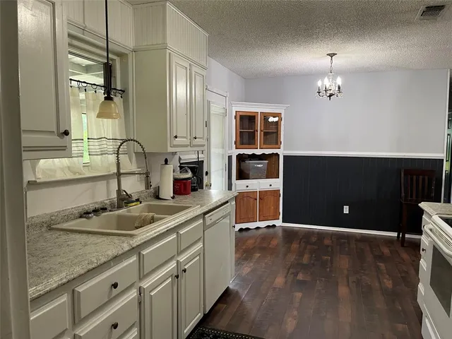 a bathroom with a sink double vanity granite and a mirror