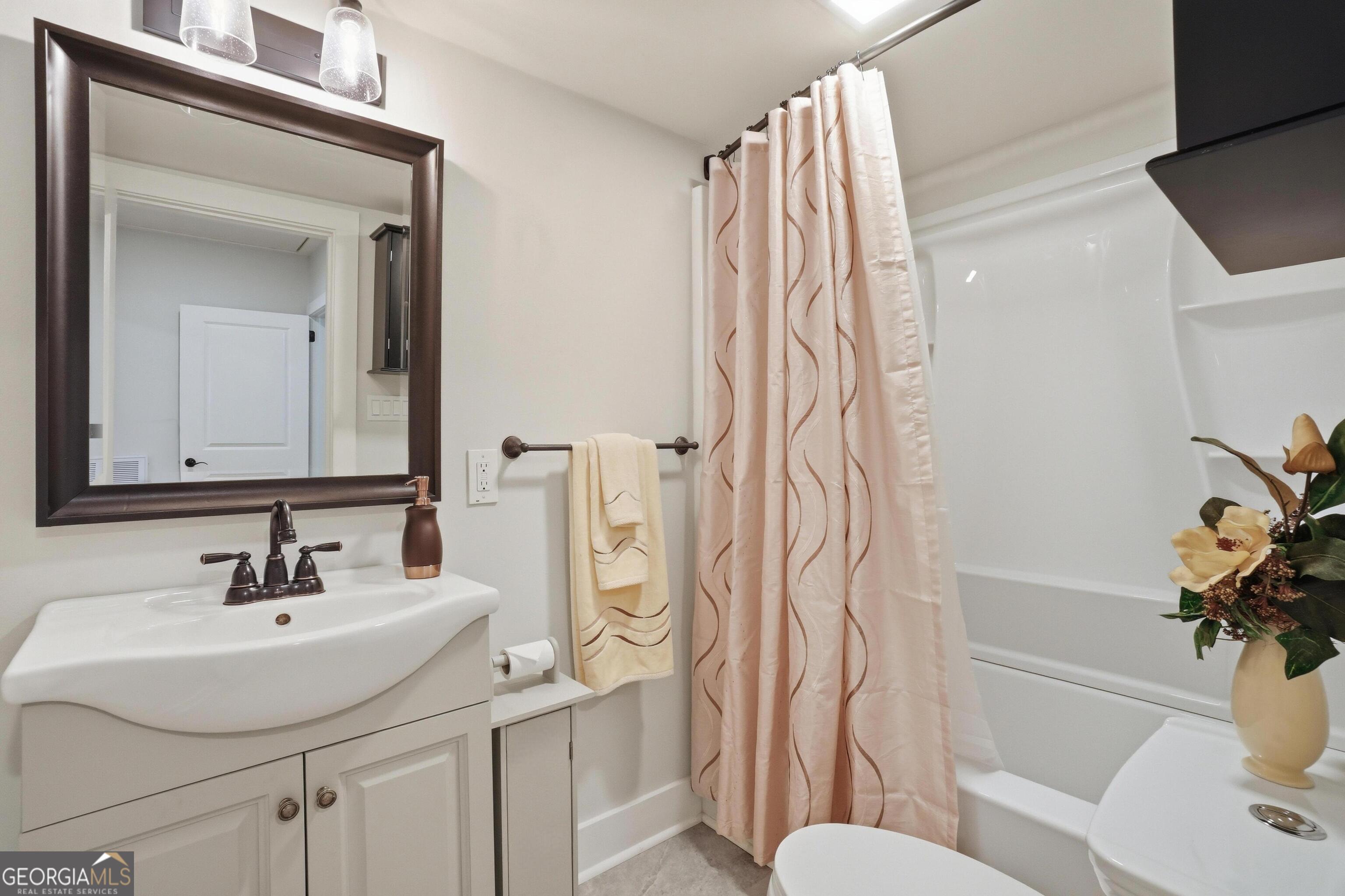 3022 Maple Road Southeast Lindale, GA 30147 - Photo 13 of 29 a bathroom with a sink toilet and shower