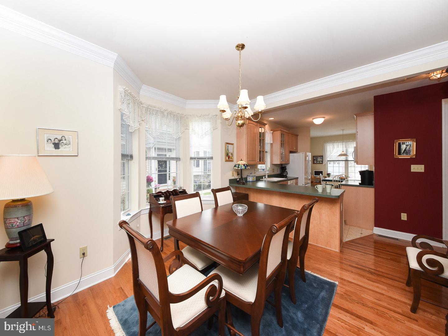 3113 Arborgreene Court Hatfield, PA 19440 - Photo 12 of 33 a dining room with wooden floor and chandelier