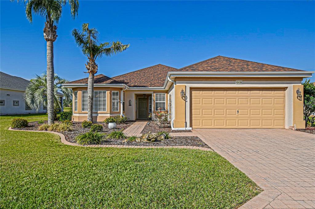 13128 Southeast 97th Terrace Road Summerfield, FL 34491 - Photo 1 of 1 a front view of a house with garden