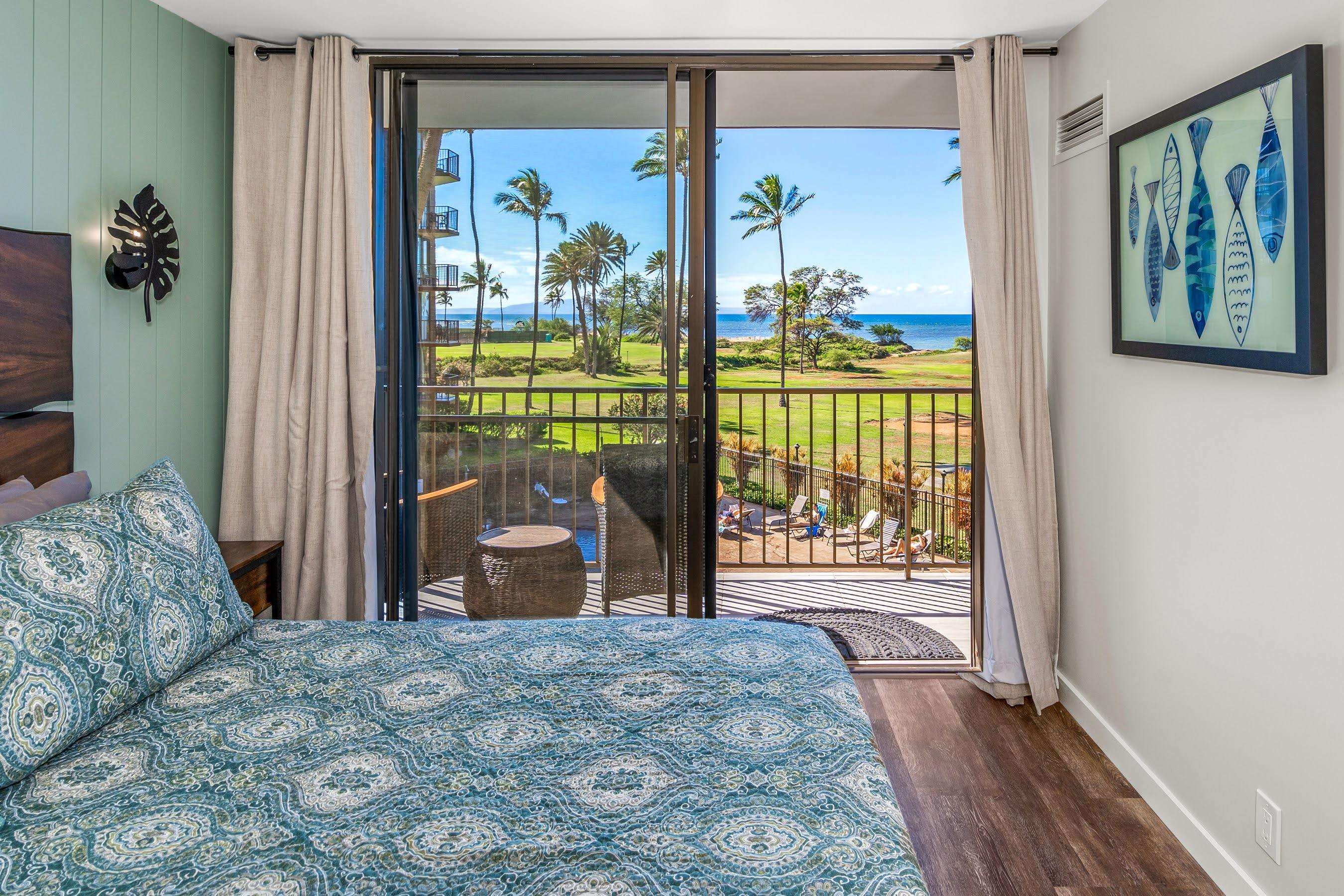 938 South Kihei Road, Unit 309 Kihei, HI 96753 - Photo 31 of 34 a bedroom with a bed and wooden floor