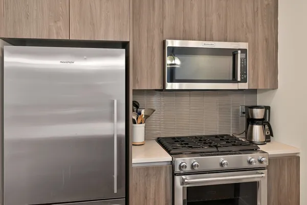 a stove top oven sitting inside of a kitchen