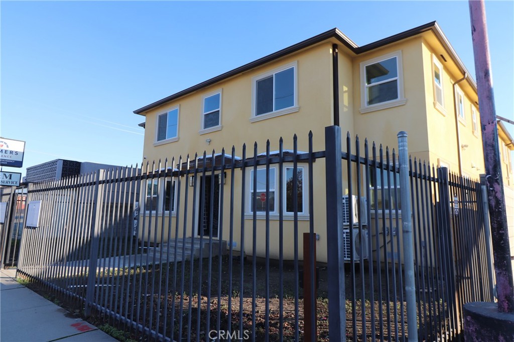 a view of a house with wooden fence