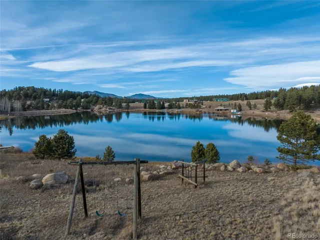 a view of a lake with houses in back