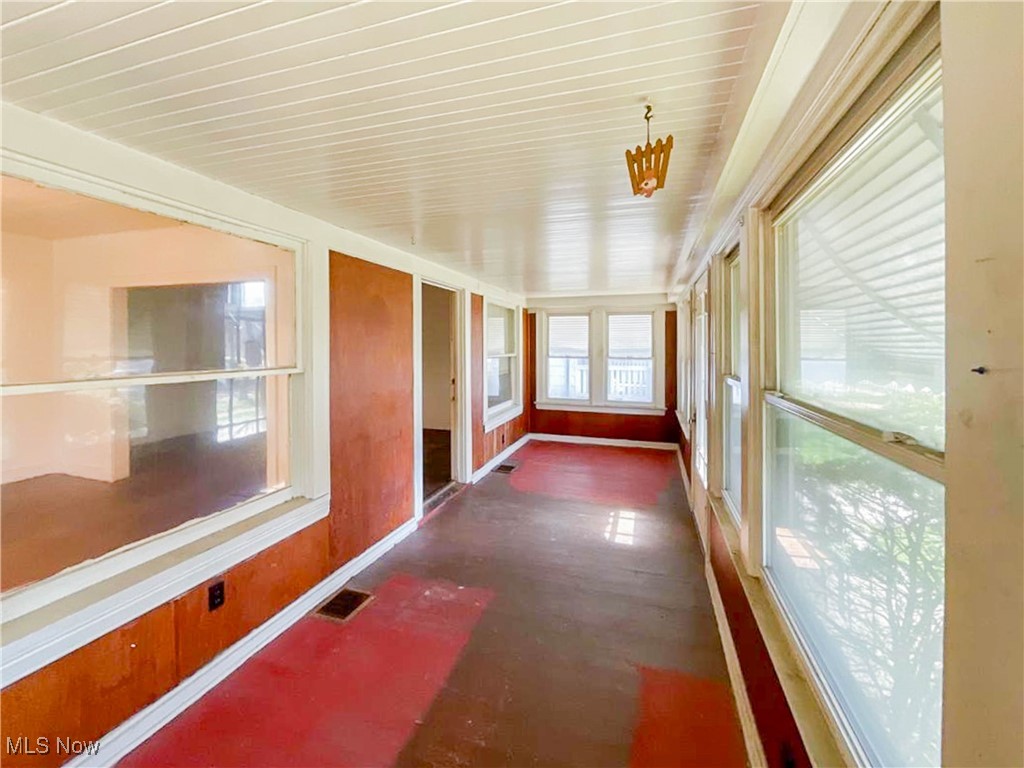 14703 Granger Road Maple Heights, OH 44137 - Photo 23 of 35 Unfurnished sunroom featuring visible vents and baseboards