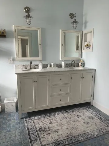 a bedroom with a bed and a rug