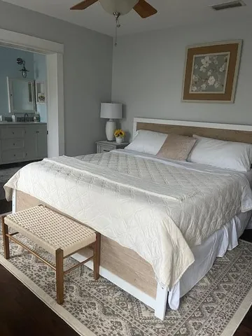 a bedroom with a bed and a lamp