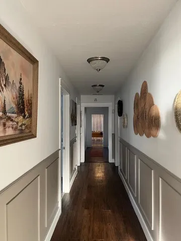 a living room with furniture and chandelier