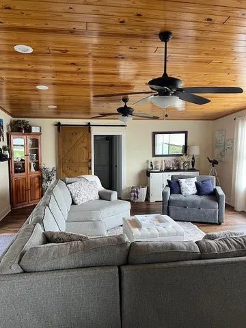 a living room with furniture and a ceiling fan