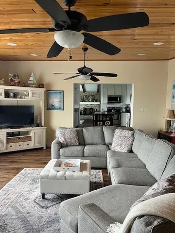 a kitchen with stainless steel appliances a table chairs and refrigerator
