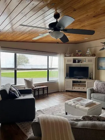 a kitchen with granite countertop a stove a sink and a refrigerator