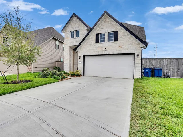 a view of a yard in front view of a house
