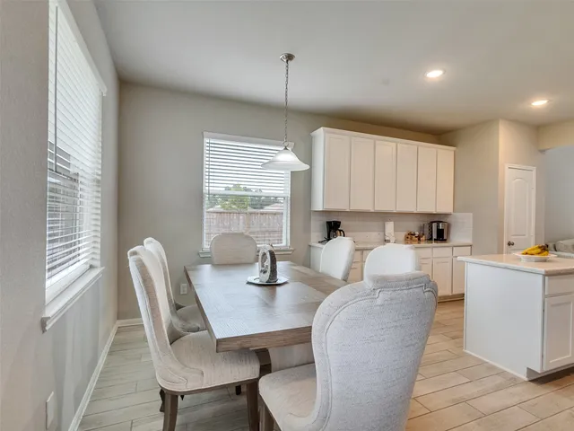 a view of a dining room with furniture and window