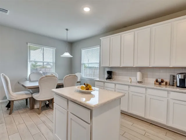 a view of a kitchen with a sink and cabinets