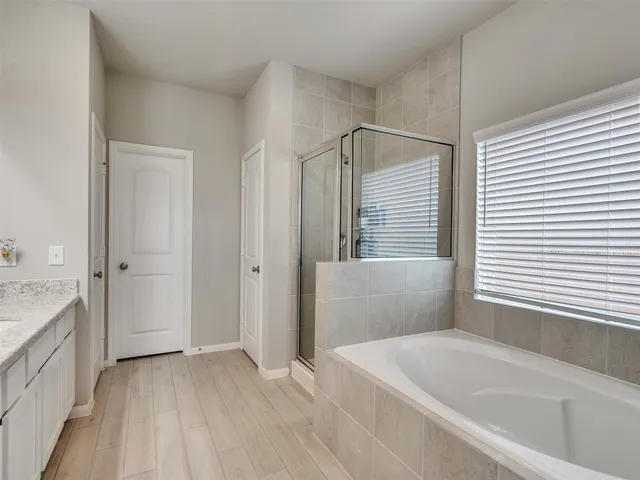 a bathroom with a bathtub and a sink