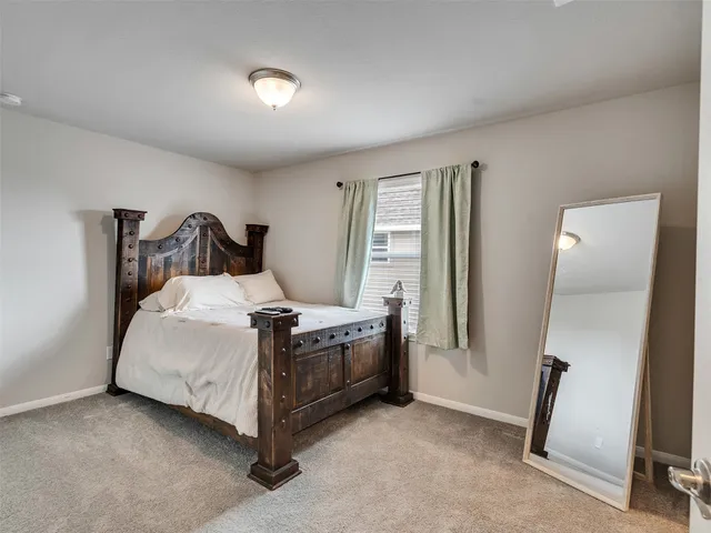 a bed sitting in a room next to a window