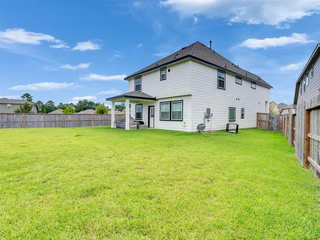 a view of a house with a yard porch and sitting area