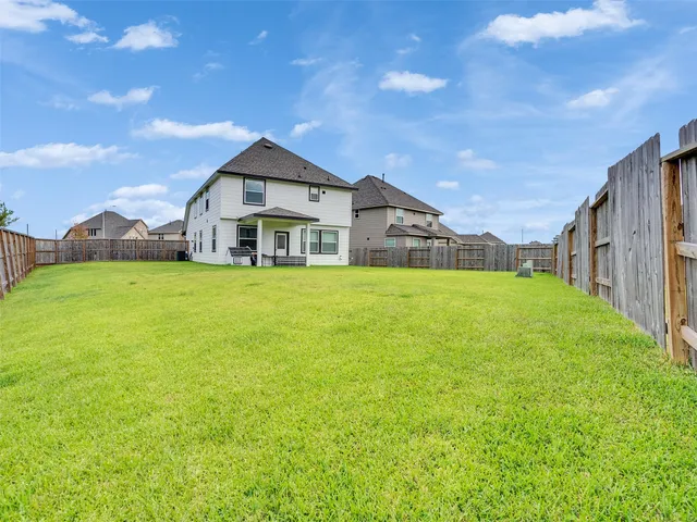 a view of a house with a yard and garage