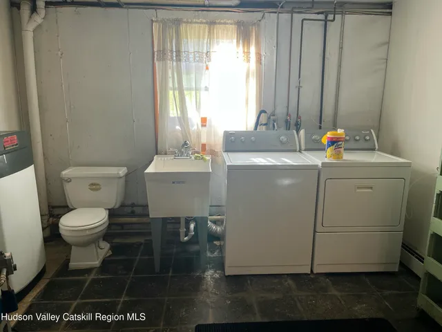 a bathroom with a toilet a sink and a window