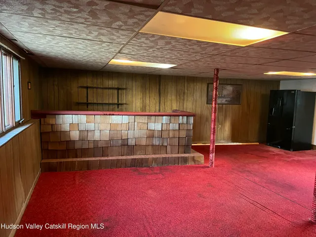 a view of a room with wooden floor and windows