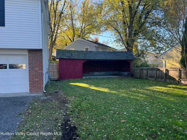 a house is sitting in middle of the green field