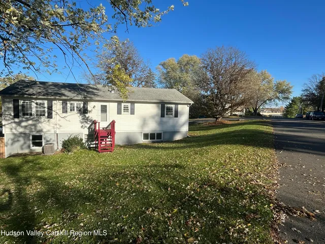 a view of a house with backyard sitting area and garden