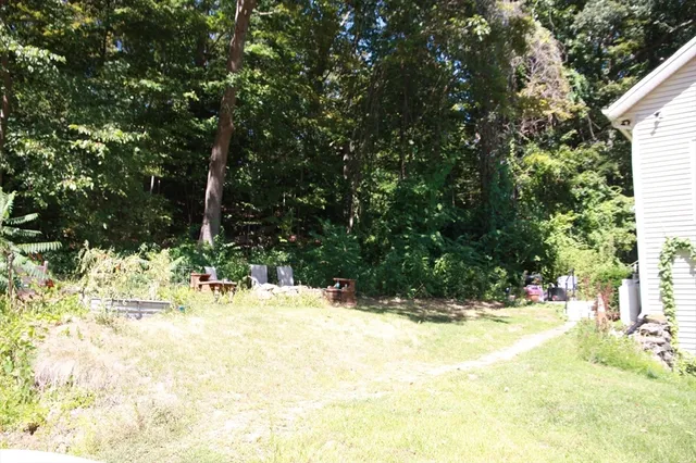 a view of pool with a yard