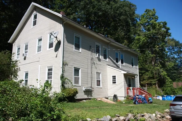 a view of house with a yard