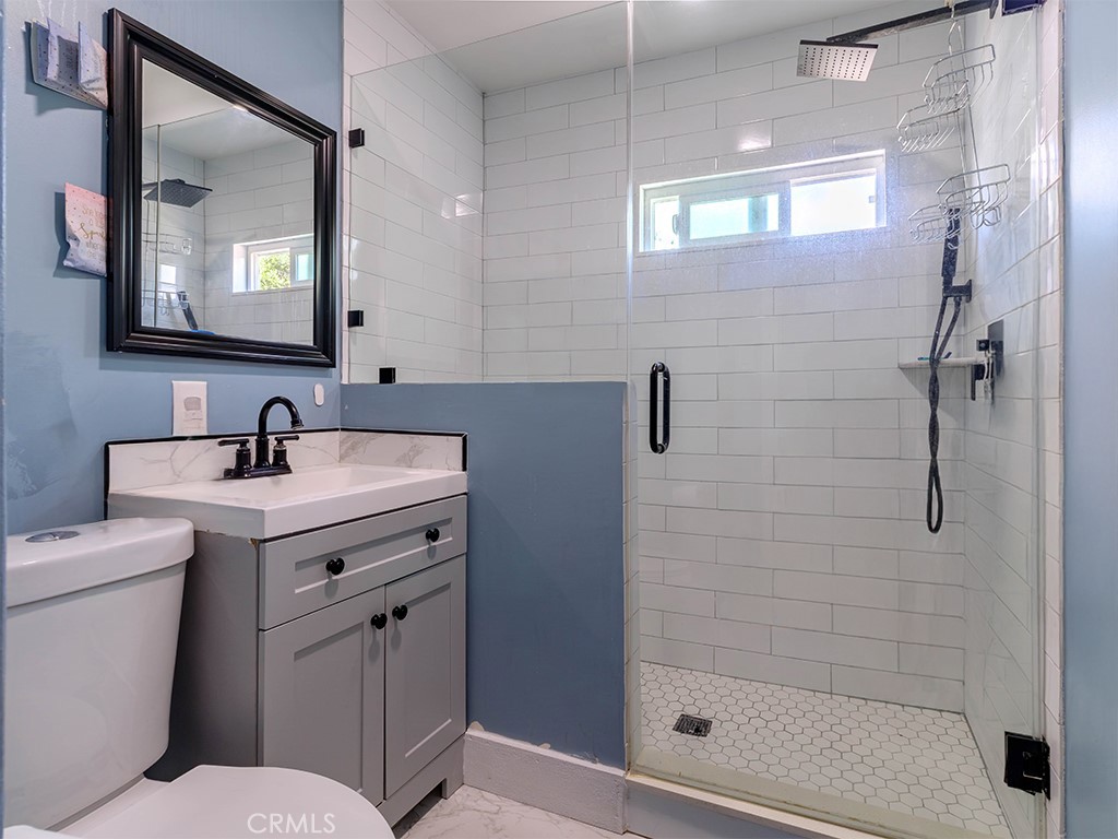 1130 West Chestnut Avenue Santa Ana, CA 92703 - Photo 11 of 20 a bathroom with a shower sink vanity and mirror