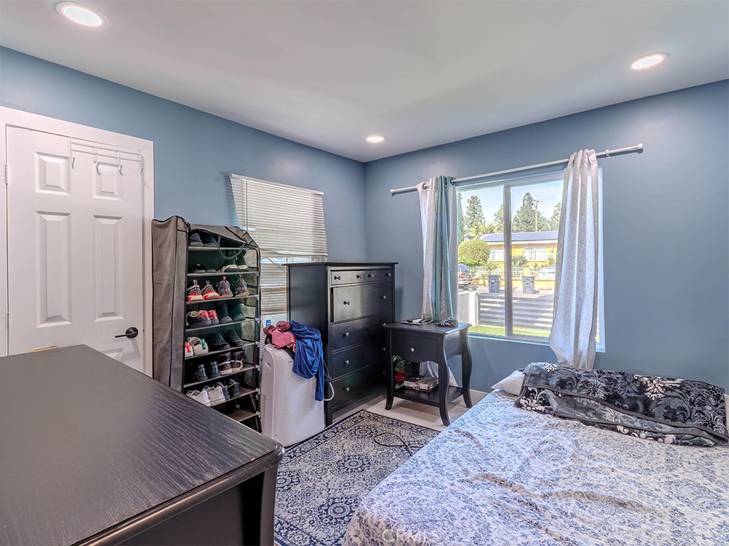 1130 West Chestnut Avenue Santa Ana, CA 92703 - Photo 12 of 20 a bedroom with furniture and a flat screen tv