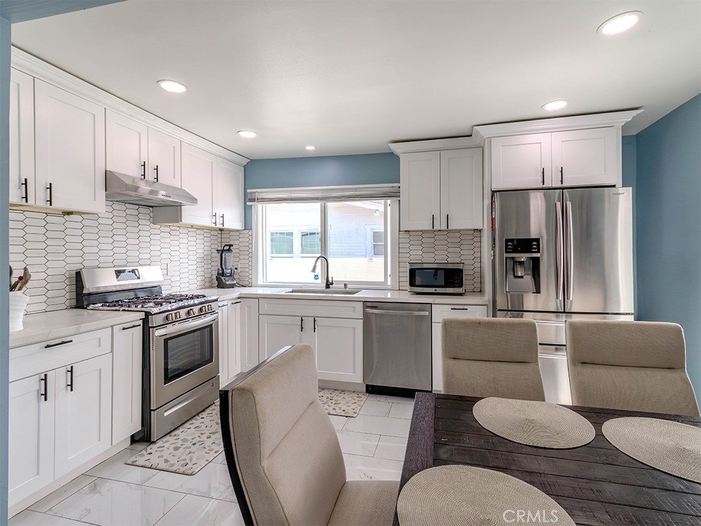 1130 West Chestnut Avenue Santa Ana, CA 92703 - Photo 4 of 20 a kitchen with stainless steel appliances granite countertop a refrigerator sink and cabinets