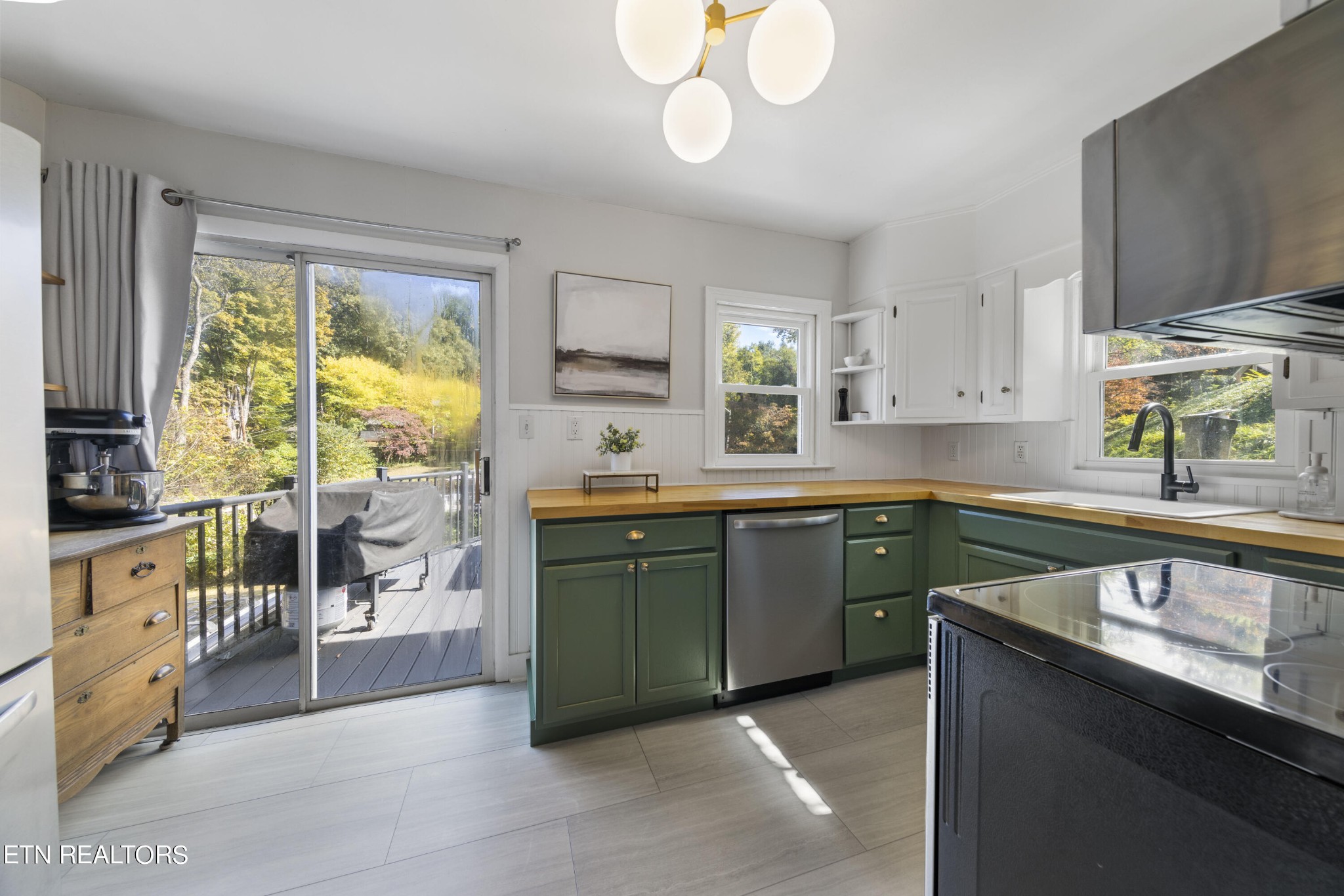 405 Mark Road Knoxville, TN 37920 - Photo 11 of 24 a kitchen with kitchen island granite countertop a sink appliances cabinets and a large window