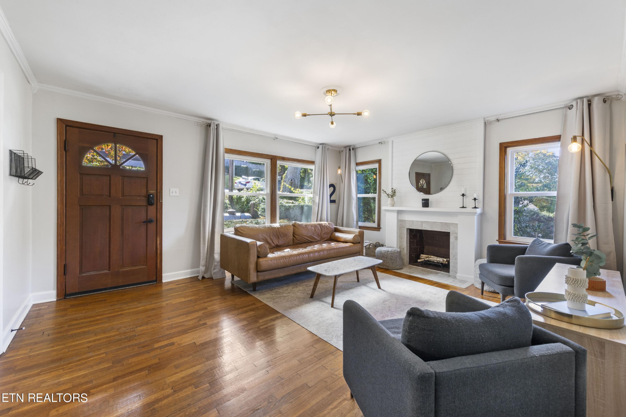 405 Mark Road Knoxville, TN 37920 - Photo 6 of 24 a living room with furniture a fireplace and a large window