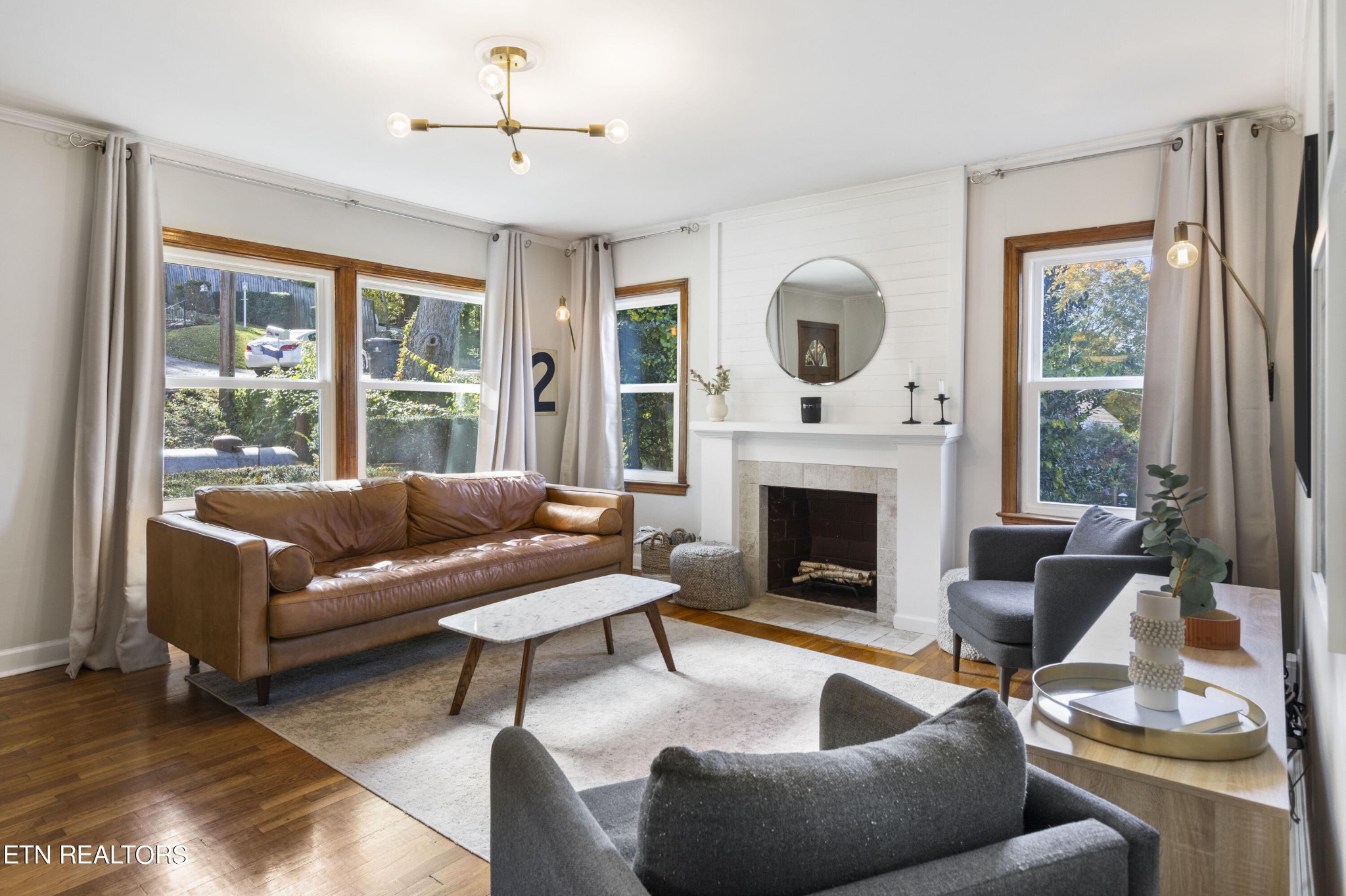 405 Mark Road Knoxville, TN 37920 - Photo 7 of 24 a living room with furniture a fireplace and a floor to ceiling window