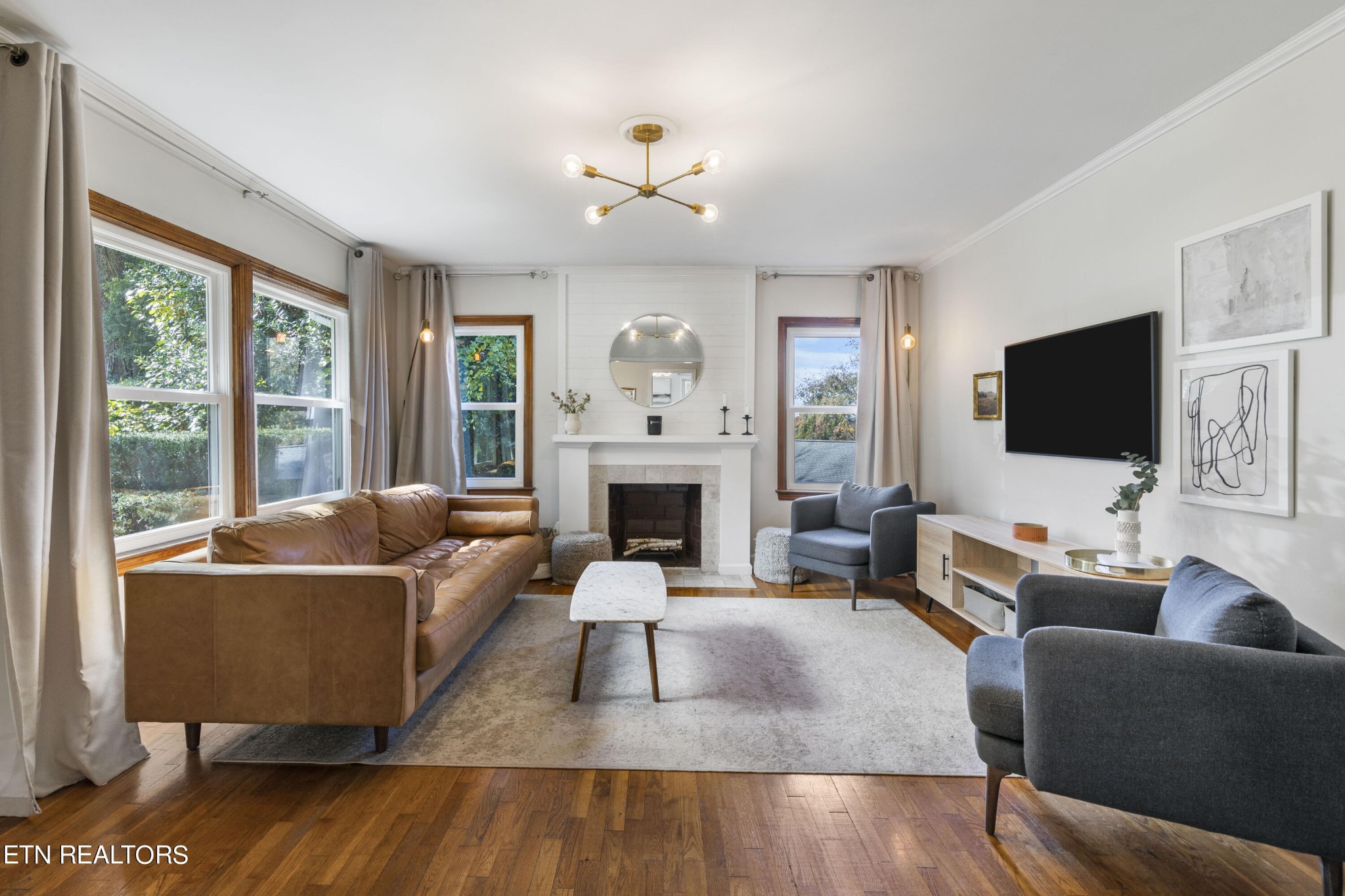 405 Mark Road Knoxville, TN 37920 - Photo 8 of 24 a living room with furniture flat screen tv and a fireplace